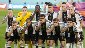Немецкие футболисты прикрыли рты руками на фото перед матчем с Японией